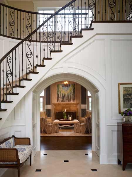 wrought iron staircase with white panel walls